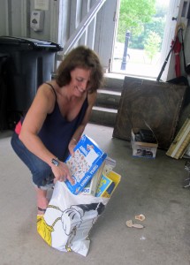 Malene Coombs gathers up some board games for students at the Boston school where she teaches.