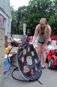 Grace Sweetser checks out a discarded toy that she thought might be fun for the beach.