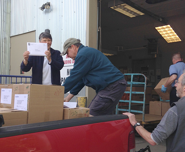 Belinda Gingrich and volunteers from the Friends of the Lincoln Library unload the 2015 Lincoln telephone directory at the post office on May 20 in preparation for delivery to every household in Lincoln. 